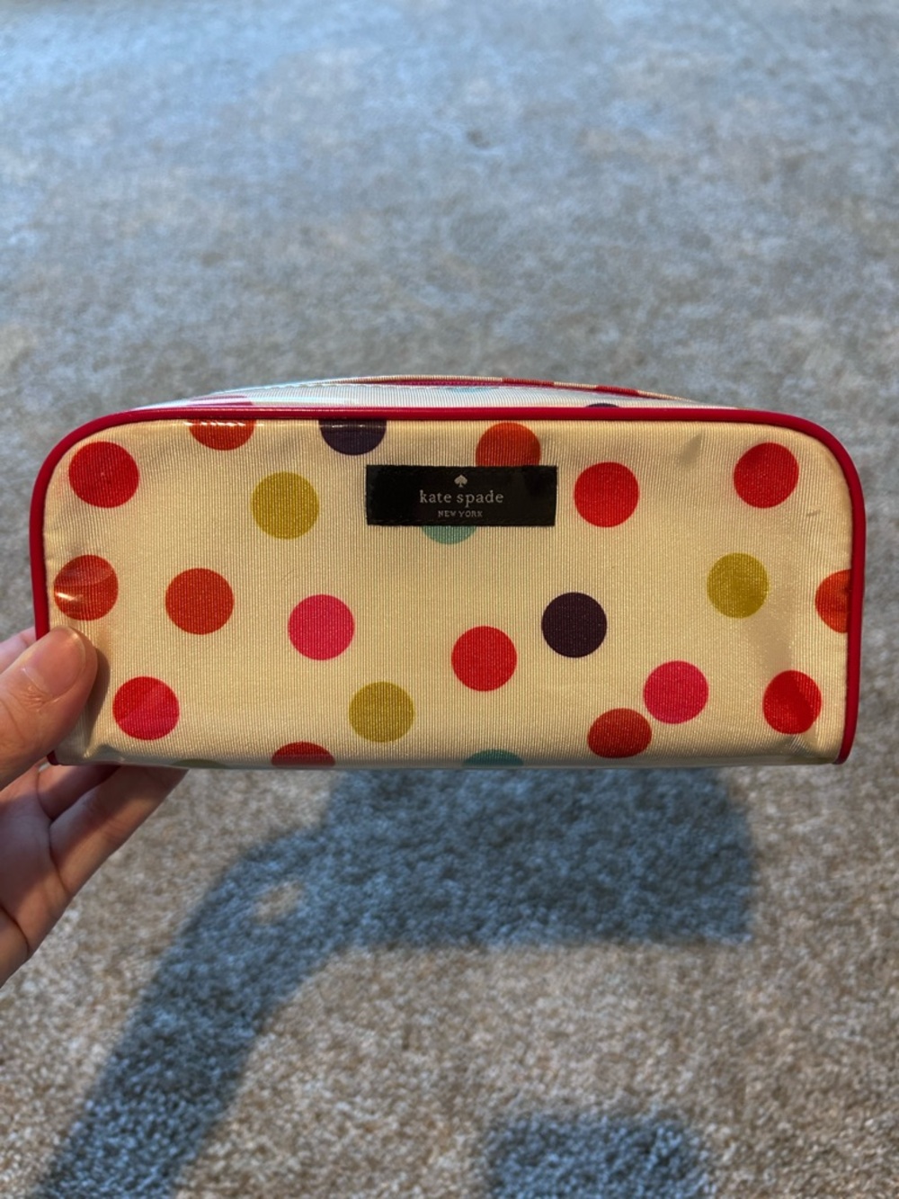 kate spade cream polka dot cosmetic pouch with red trim